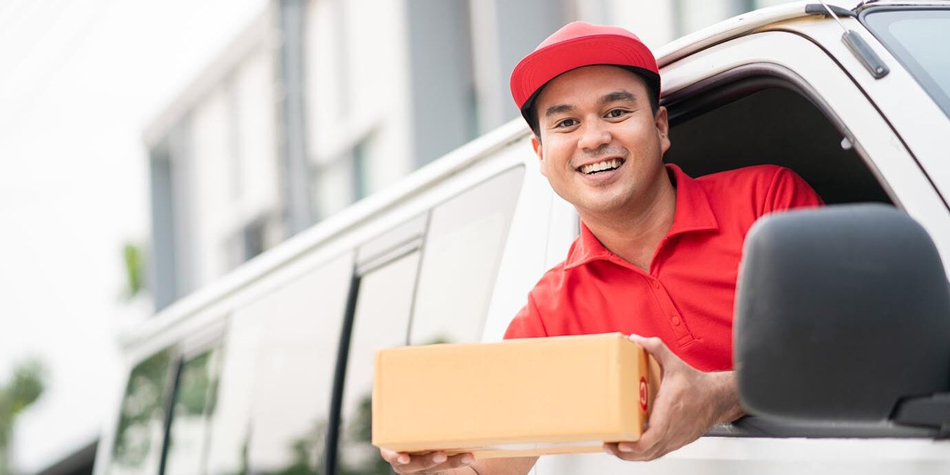 young-delivery-man-red-uniform-driving-truck-sending-parcel