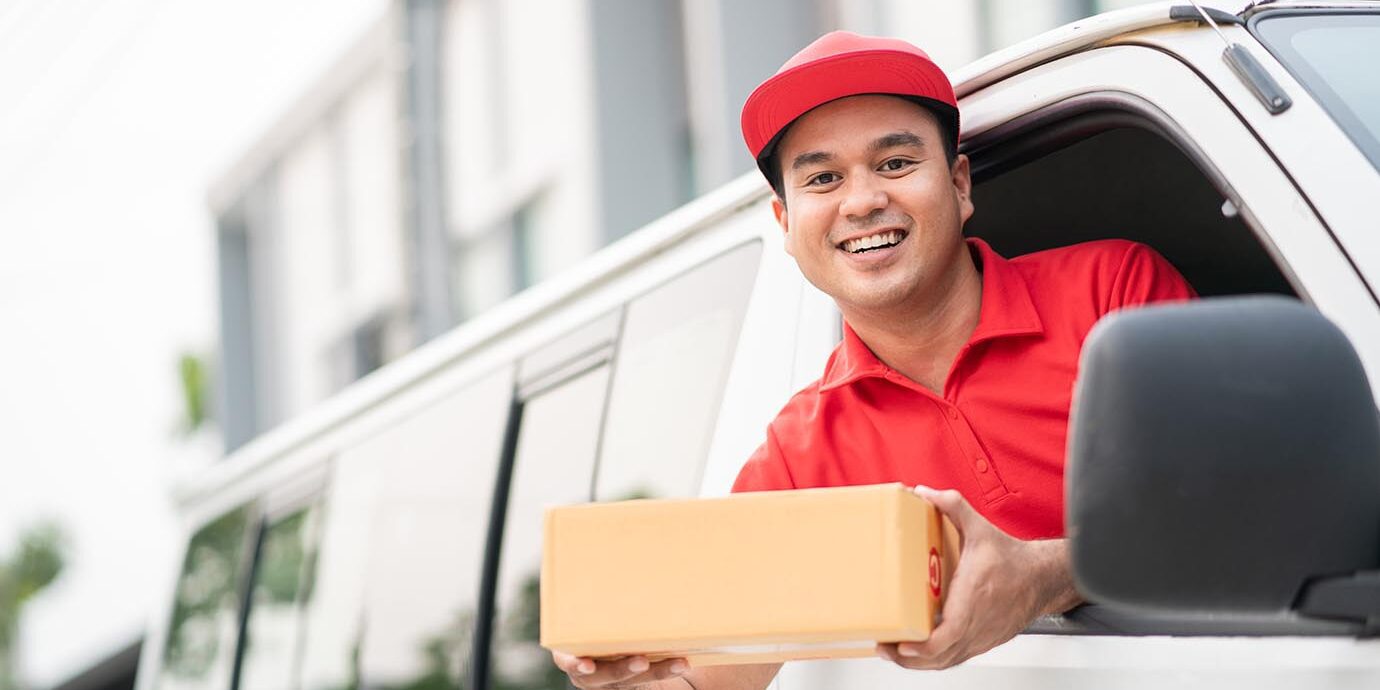 young-delivery-man-red-uniform-driving-truck-sending-parcel young-delivery-man-red-uniform-driving-truck-sending-parcel
